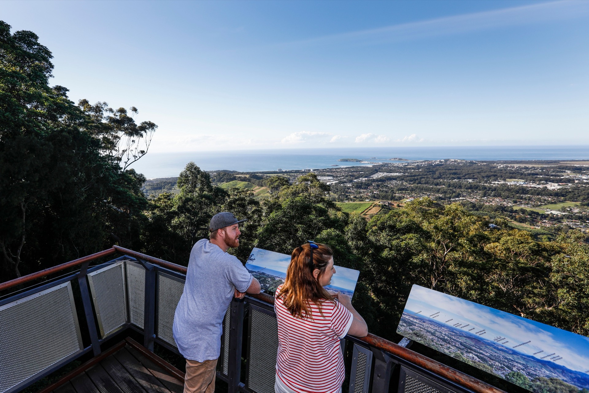 Visitors on Forest Sky Pier overlooking forest and coast near Coffs Harbour