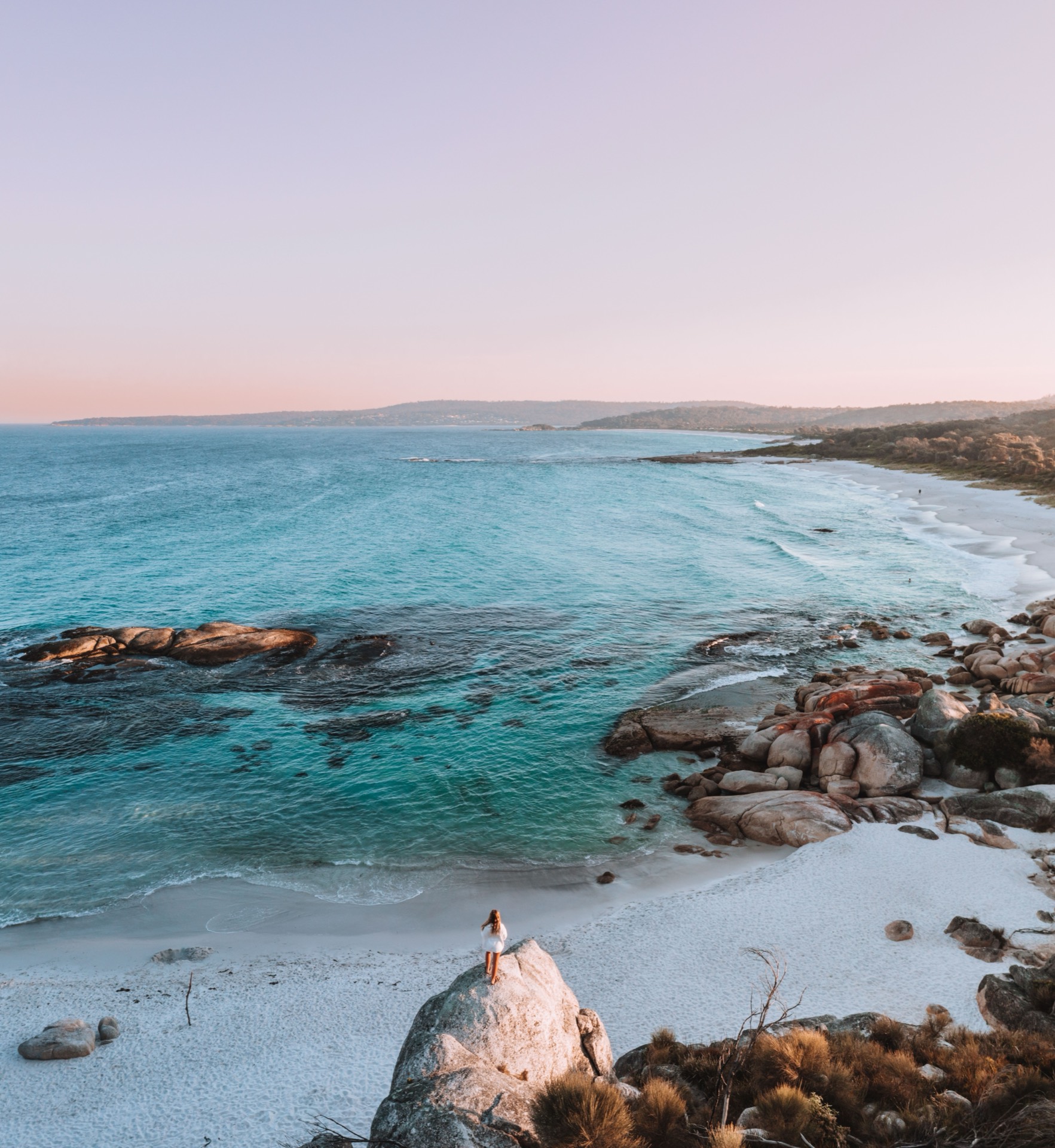 Orange granite boulders and pale beach at Cosy Corner in the Bay of Fires
